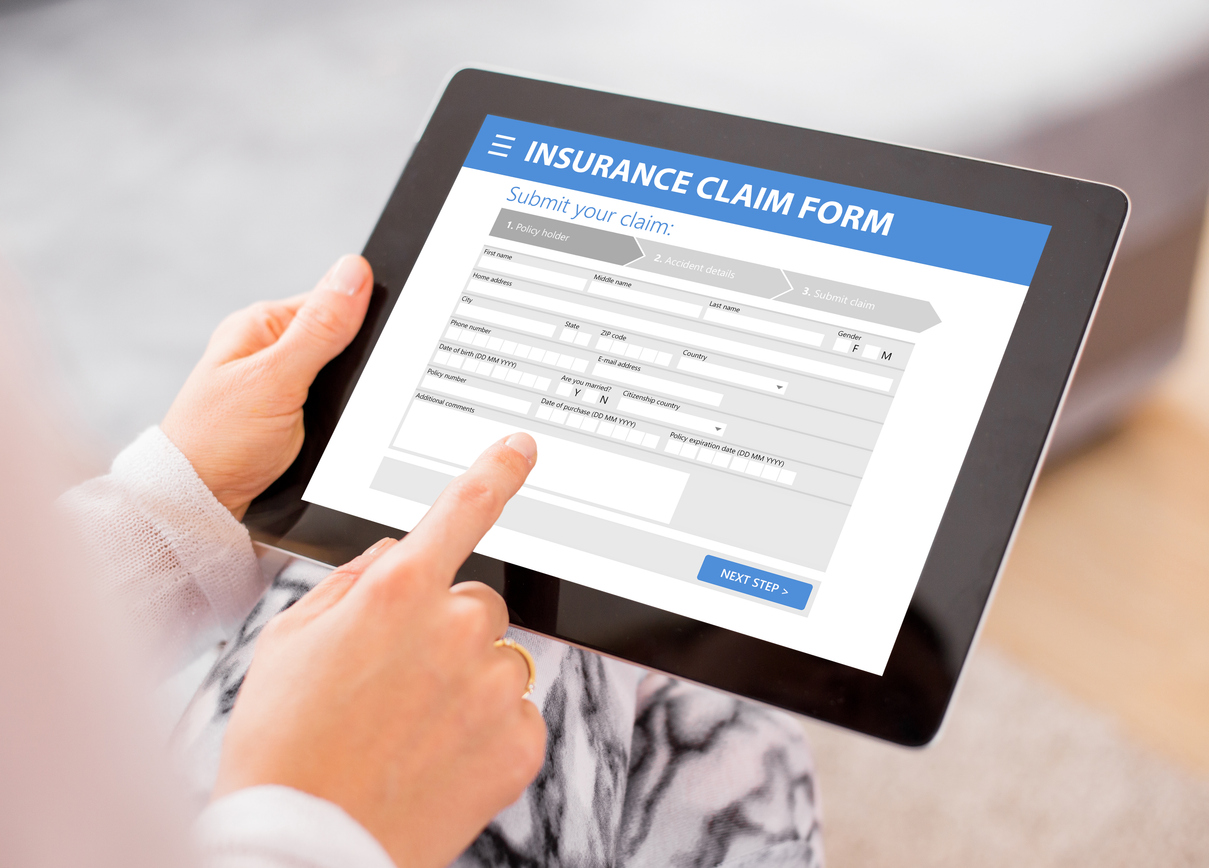 Insurance claim documentation with photos, forms, and moisture meter